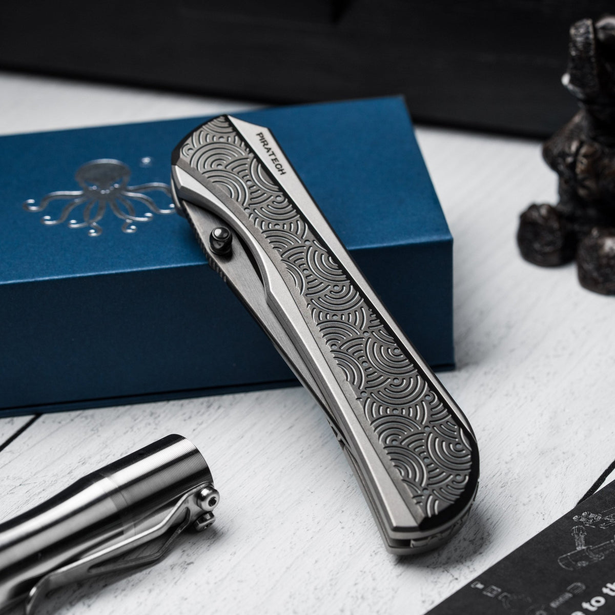 Drop Date (04/15): Piratech x URBAN Saga - Satin DLC S90V & Zir Blasted Titanium w/ Bead Blast DLC Chaos Seigaiha™ - URBAN EDC®